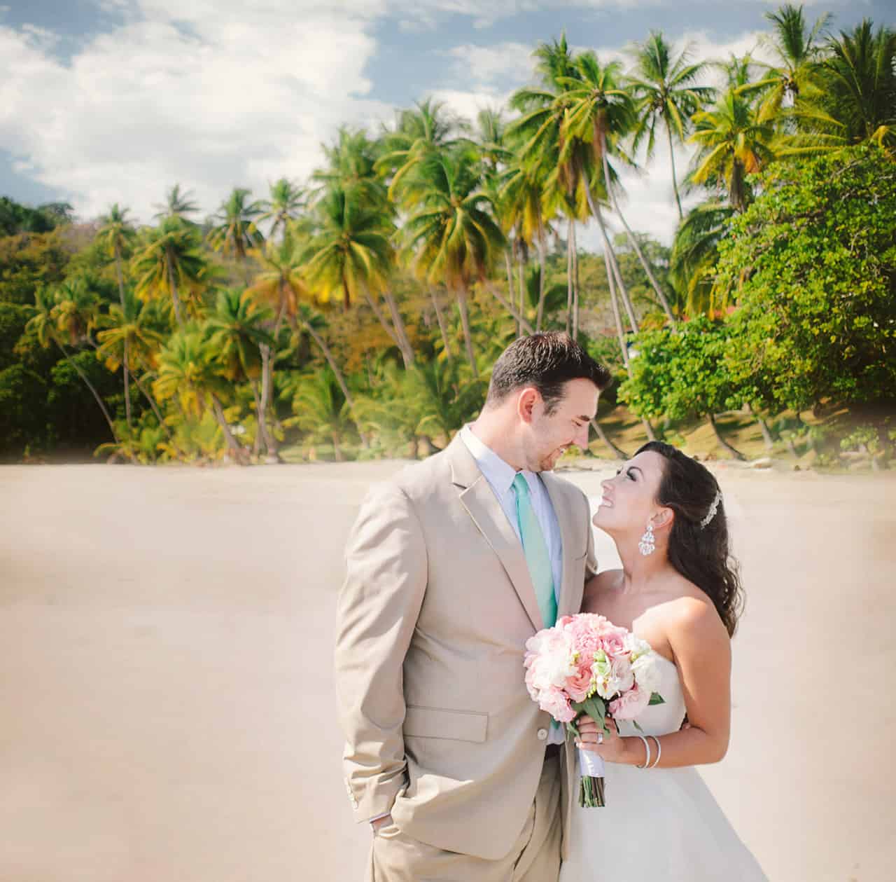 smiling married couple on beach